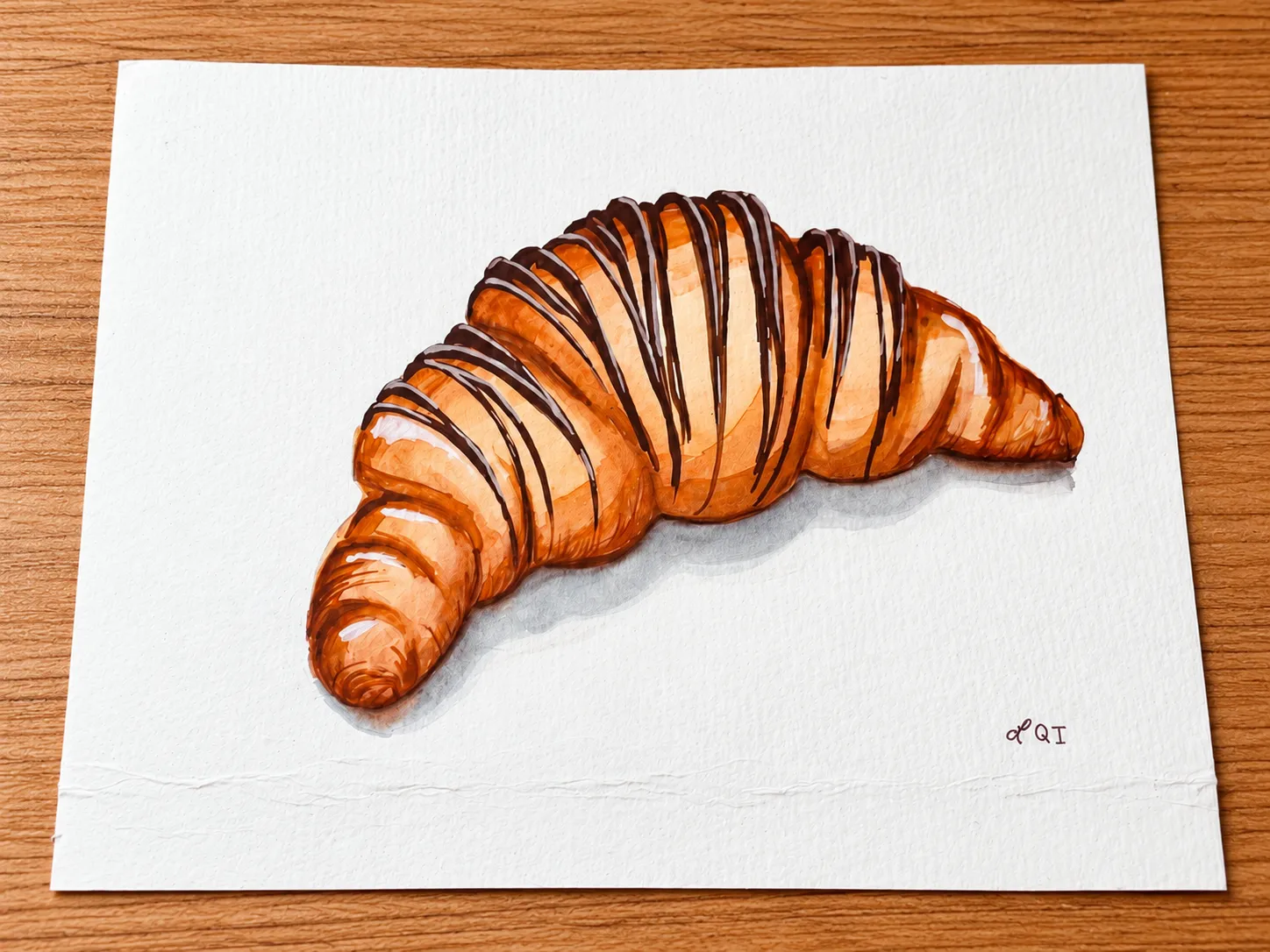 Chocolate-drizzled croissant watercolor on a wooden table