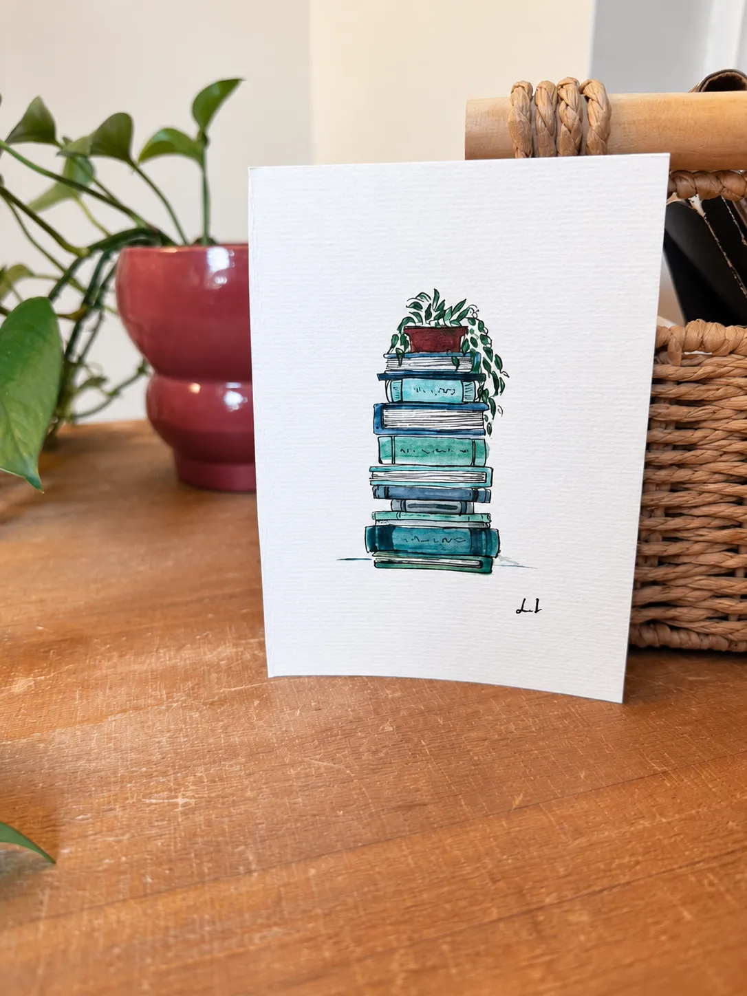 The Reading Nook - Teal standing beside a plant and woven basket